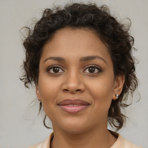 Joyful black young-adult female with medium  brown hair and brown eyes