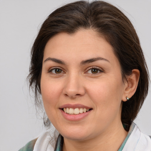 Joyful white young-adult female with medium  brown hair and brown eyes