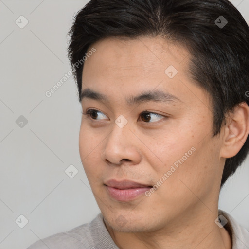 Joyful asian young-adult male with short  brown hair and brown eyes