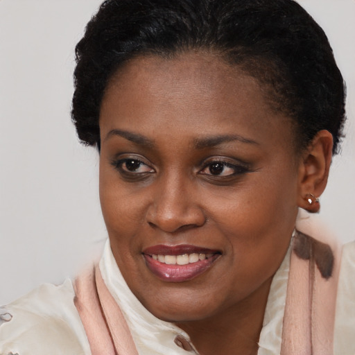 Joyful black young-adult female with short  brown hair and brown eyes