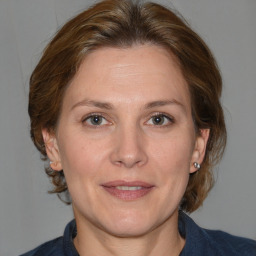 Joyful white adult female with medium  brown hair and grey eyes