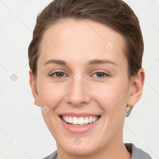 Joyful white young-adult female with short  brown hair and grey eyes