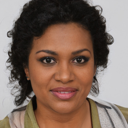 Joyful black young-adult female with medium  brown hair and brown eyes
