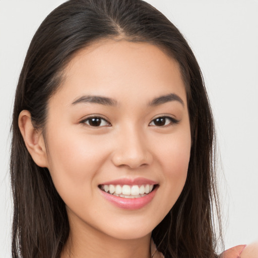 Joyful white young-adult female with long  brown hair and brown eyes