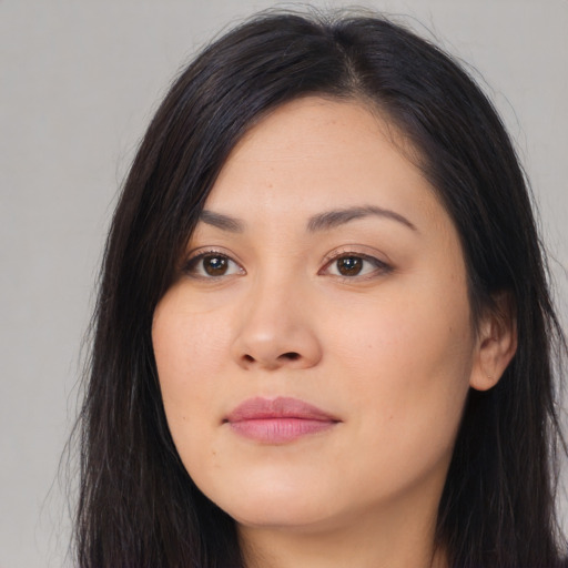 Joyful asian young-adult female with long  black hair and brown eyes
