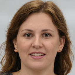 Joyful white adult female with medium  brown hair and brown eyes