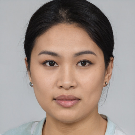 Joyful asian young-adult female with medium  brown hair and brown eyes