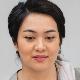 Joyful asian young-adult female with medium  black hair and brown eyes