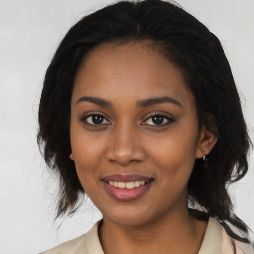 Joyful black young-adult female with medium  black hair and brown eyes