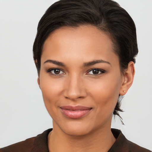 Joyful latino young-adult female with short  brown hair and brown eyes