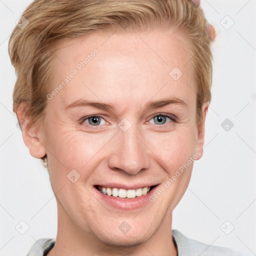 Joyful white adult female with short  brown hair and blue eyes