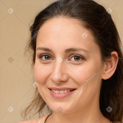 Joyful white young-adult female with long  brown hair and brown eyes