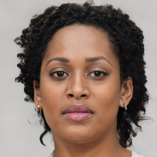 Neutral black young-adult female with long  brown hair and brown eyes