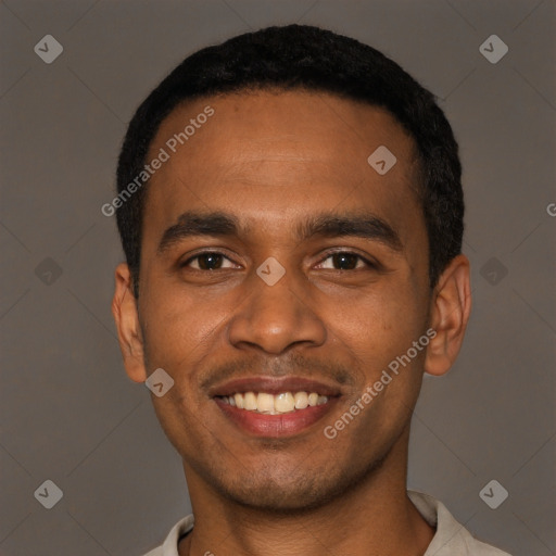 Joyful black young-adult male with short  black hair and brown eyes