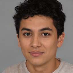 Joyful latino young-adult male with short  brown hair and brown eyes