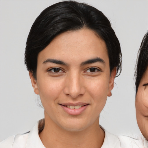 Joyful asian young-adult female with medium  brown hair and brown eyes