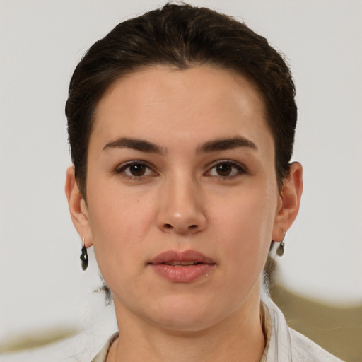 Joyful white young-adult female with short  brown hair and brown eyes