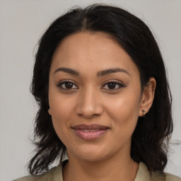 Joyful latino young-adult female with medium  black hair and brown eyes