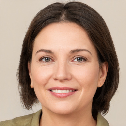 Joyful white adult female with medium  brown hair and brown eyes