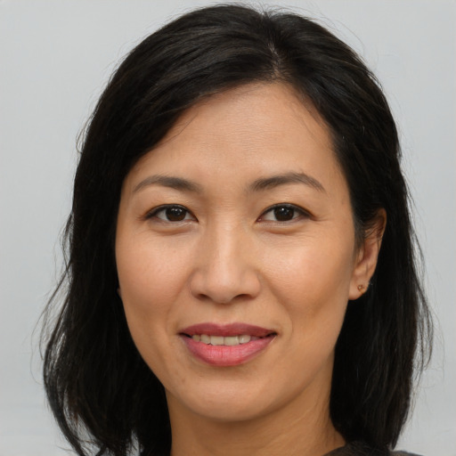 Joyful asian adult female with medium  brown hair and brown eyes