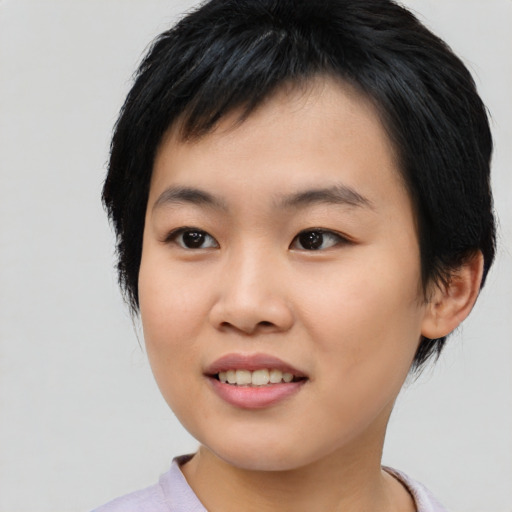 Joyful asian young-adult female with short  black hair and brown eyes