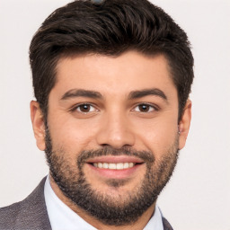Joyful white young-adult male with short  black hair and brown eyes