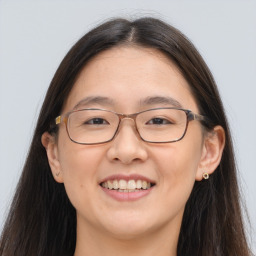 Joyful white adult female with long  brown hair and brown eyes