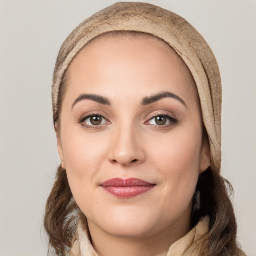 Joyful white young-adult female with long  brown hair and brown eyes