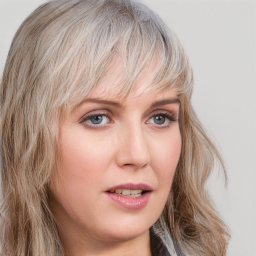 Joyful white young-adult female with medium  blond hair and blue eyes