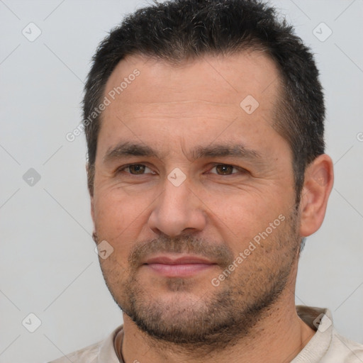 Joyful white adult male with short  brown hair and brown eyes