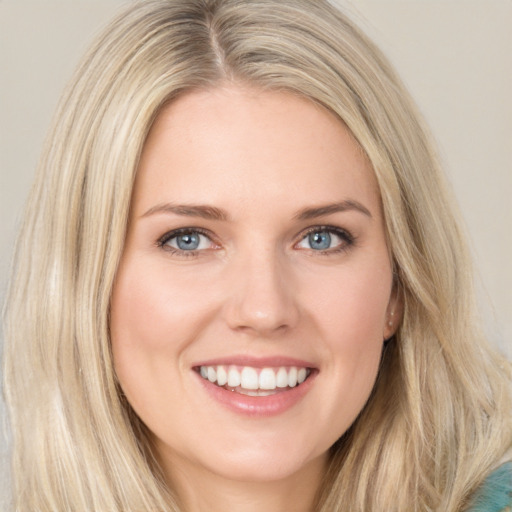 Joyful white young-adult female with long  brown hair and blue eyes