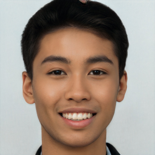 Joyful latino young-adult male with short  brown hair and brown eyes