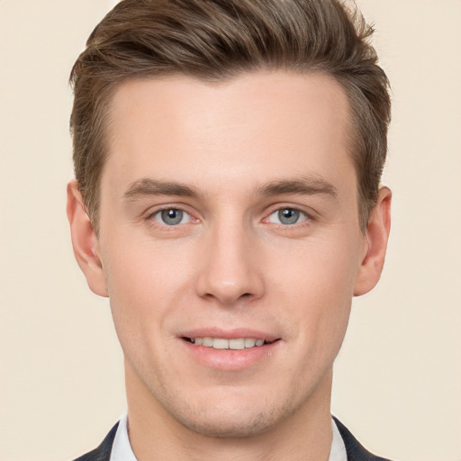 Joyful white young-adult male with short  brown hair and grey eyes