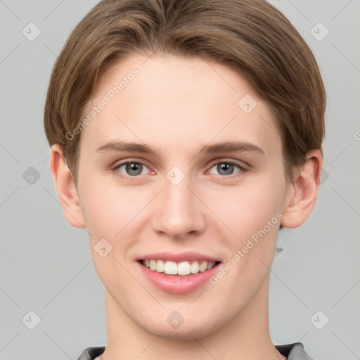 Joyful white young-adult female with short  brown hair and grey eyes