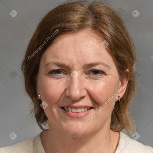 Joyful white adult female with medium  brown hair and blue eyes