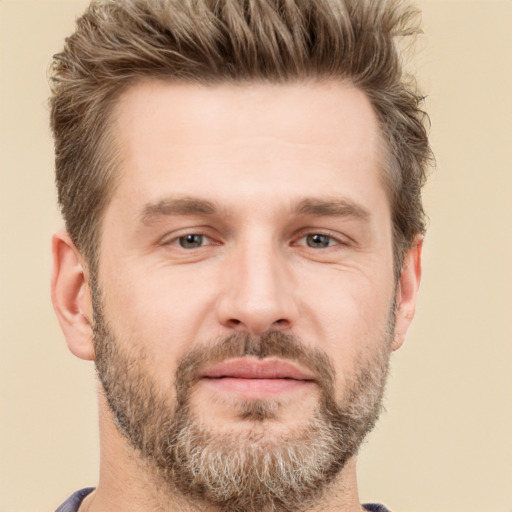 Joyful white adult male with short  brown hair and brown eyes