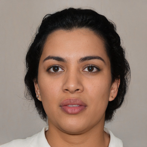 Joyful latino young-adult female with medium  black hair and brown eyes