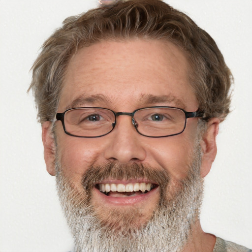 Joyful white middle-aged male with short  brown hair and blue eyes