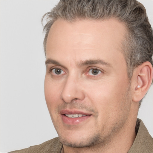 Joyful white adult male with short  brown hair and brown eyes