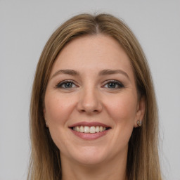 Joyful white young-adult female with long  brown hair and grey eyes