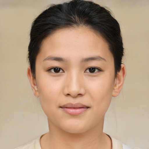 Joyful asian young-adult female with short  brown hair and brown eyes