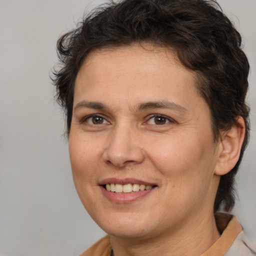 Joyful white adult female with medium  brown hair and brown eyes