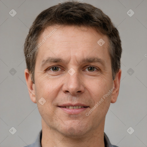 Joyful white adult male with short  brown hair and brown eyes