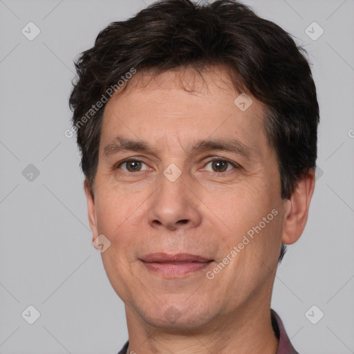 Joyful white adult male with short  brown hair and brown eyes