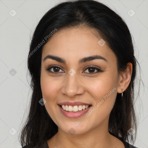 Joyful latino young-adult female with long  brown hair and brown eyes