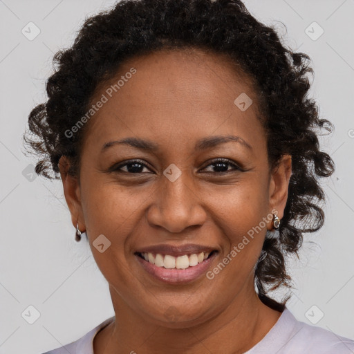 Joyful black adult female with short  brown hair and brown eyes