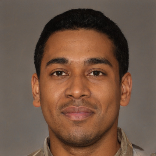 Joyful latino young-adult male with short  brown hair and brown eyes
