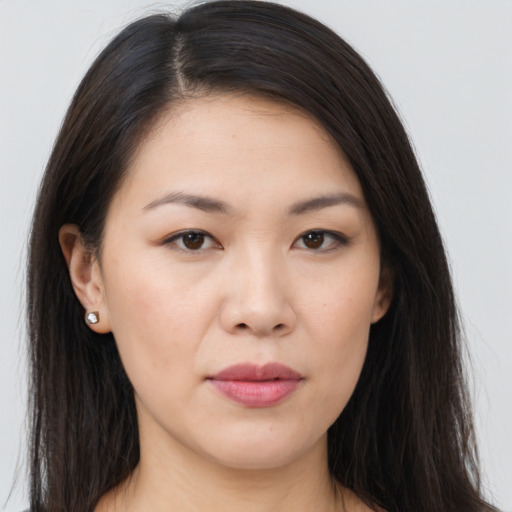 Joyful asian young-adult female with long  brown hair and brown eyes