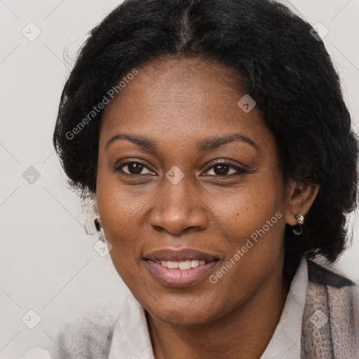 Joyful black adult female with short  brown hair and brown eyes