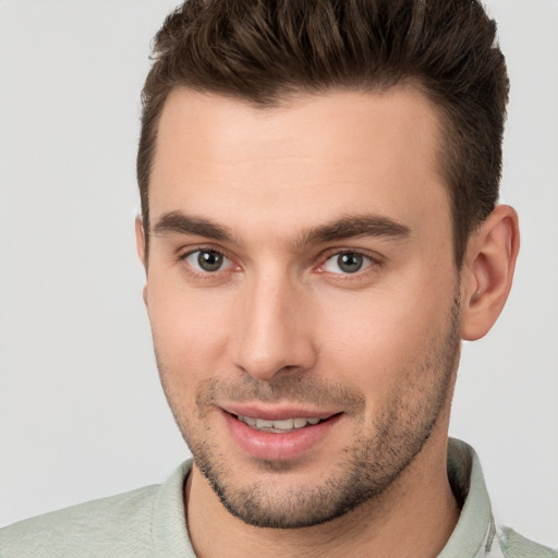 Joyful white young-adult male with short  brown hair and brown eyes